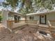 A wrap-around wooden deck enhances this home's exterior, offering an outdoor space with access to the main entrance at 914 Mangham Rd, Babson Park, FL 33827