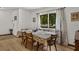 Cozy dining area with a table set for six, large window offering natural light, and stylish curtains at 914 Mangham Rd, Babson Park, FL 33827