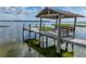 View of dock with shelter at the end of a sandy beach and stairs to the water at 914 Mangham Rd, Babson Park, FL 33827