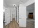 This hallway features wood-look flooring, a closet, and doors leading to other rooms in the house at 914 Mangham Rd, Babson Park, FL 33827