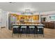 Spacious kitchen with a large island and barstool seating, complemented by wooden cabinetry and stainless steel appliances at 914 Mangham Rd, Babson Park, FL 33827
