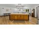 Spacious island with marble countertops, wooden drawers, storage cabinets and rustic charm in a well-lit kitchen area at 914 Mangham Rd, Babson Park, FL 33827