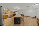 Spacious open-concept kitchen featuring an island with seating, wooden cabinetry, and stainless steel appliances with an inviting layout at 914 Mangham Rd, Babson Park, FL 33827
