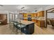 Well-lit kitchen with a sizable island, stainless appliances, decorative backsplash, and warm-toned wooden cabinetry at 914 Mangham Rd, Babson Park, FL 33827