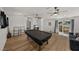 Open floor plan with pool table, ceiling fans, and access to the outdoor deck at 914 Mangham Rd, Babson Park, FL 33827