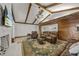 Comfortable living room with exposed beams, a stone fireplace, and open access to the kitchen at 914 Mangham Rd, Babson Park, FL 33827