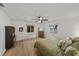 Bright main bedroom features two windows offering serene water views, a ceiling fan, and wood-look flooring at 914 Mangham Rd, Babson Park, FL 33827
