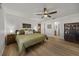This spacious bedroom boasts wood-look flooring, a stylish ceiling fan, and a convenient ensuite bathroom at 914 Mangham Rd, Babson Park, FL 33827