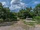 Expansive lot with mature trees and a boat on concrete pad ready for lake adventures at 914 Mangham Rd, Babson Park, FL 33827