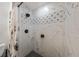 Close-up of a shower featuring decorative tile work and modern black fixtures at 914 Mangham Rd, Babson Park, FL 33827