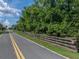 Street view of the property with fencing bordering the road at 914 Mangham Rd, Babson Park, FL 33827