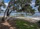 Scenic waterfront view of the lake featuring the beach and shared dock at 914 Mangham Rd, Babson Park, FL 33827
