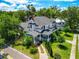 Stunning aerial view of the classic home with mature trees, showing the architecture and manicured landscape at 103 Se Tuscawilla Ave, Ocala, FL 34471