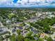 Expansive aerial view of the community showcasing lush greenery and scenic neighborhood streets on a partly cloudy day at 103 Se Tuscawilla Ave, Ocala, FL 34471