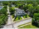 Expansive aerial view of stately home surrounded by lush greenery, showcasing its prime neighborhood location at 103 Se Tuscawilla Ave, Ocala, FL 34471