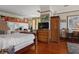 Bedroom with double bed, hardwood floors, and vintage decor at 103 Se Tuscawilla Ave, Ocala, FL 34471
