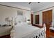 Bright bedroom with white furniture, ceiling fan, wooden floors, and natural light at 103 Se Tuscawilla Ave, Ocala, FL 34471