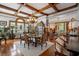 Elegant dining room featuring a coffered ceiling, hardwood floors, and a grand chandelier at 103 Se Tuscawilla Ave, Ocala, FL 34471
