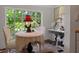 Eat-in kitchen featuring natural light from the garden view with a cozy table and vintage decor at 103 Se Tuscawilla Ave, Ocala, FL 34471