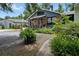 Charming home with a inviting front porch, lush landscaping, and decorative wooden shutters at 103 Se Tuscawilla Ave, Ocala, FL 34471