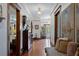 Elegant hallway with hardwood floors, beautiful wood trim, and decorative elements for a welcoming ambiance at 103 Se Tuscawilla Ave, Ocala, FL 34471