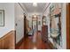 Hallway features hardwood floors, vintage cabinet, and artwork on the wall at 103 Se Tuscawilla Ave, Ocala, FL 34471