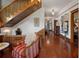 Hallway with hardwood floors, traditional wooden railings, and decorative chair at 103 Se Tuscawilla Ave, Ocala, FL 34471