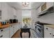 A functional kitchen area with ample white cabinets, stainless steel appliances, and butcher block counters at 103 Se Tuscawilla Ave, Ocala, FL 34471