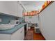 Compact kitchen with white cabinets, blue countertop, and vintage decor showcasing a cozy, functional space at 103 Se Tuscawilla Ave, Ocala, FL 34471