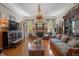 Cozy living room with a brick fireplace, wood paneling, and comfortable seating at 103 Se Tuscawilla Ave, Ocala, FL 34471