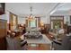 Elegant living room boasts a chandelier, hardwood floors, period furniture and natural light at 103 Se Tuscawilla Ave, Ocala, FL 34471