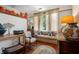 Inviting living room featuring hardwood floors, bright natural light, and unique vintage decor for a cozy, nostalgic ambiance at 103 Se Tuscawilla Ave, Ocala, FL 34471