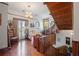 Inviting living room features hardwood floors, stained glass, and elegant staircase with traditional wood accents at 103 Se Tuscawilla Ave, Ocala, FL 34471