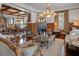 Elegant living room with a fireplace, hardwood floors, stylish seating, and natural light at 103 Se Tuscawilla Ave, Ocala, FL 34471