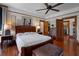Spacious main bedroom with hardwood floors, a large bed, vintage furniture, and ample natural light at 103 Se Tuscawilla Ave, Ocala, FL 34471