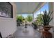 Charming porch with table, chairs, potted plants, and a blue ceiling provides a relaxing outdoor space at 103 Se Tuscawilla Ave, Ocala, FL 34471