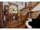 Classic wooden staircase accented by a stained glass window and vintage decor at 103 Se Tuscawilla Ave, Ocala, FL 34471