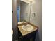 Well-lit bathroom featuring a modern vanity, granite countertops, and neutral paint with modern fixtures at 1121 W 9Th St, Lakeland, FL 33805