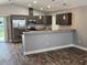 Open concept kitchen with gray cabinets, granite countertops, stainless steel appliances, and modern pendant lighting at 1121 W 9Th St, Lakeland, FL 33805