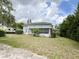 Charming home featuring a screened porch, solar panels, and a spacious lawn with mature trees at 1127 S Lakeshore Blvd, Lake Wales, FL 33853
