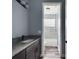 A bathroom features granite countertops, a vanity, and bathtub with tiled walls and a glass block window at 1264 Buckeye Ne Rd, Winter Haven, FL 33881