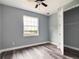 This bedroom features a closet, wood-look flooring, a ceiling fan, and a view of the water at 1264 Buckeye Ne Rd, Winter Haven, FL 33881