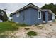 Corner angle shows the home's stucco exterior, roof line, and adjacent patio area at 1264 Buckeye Ne Rd, Winter Haven, FL 33881