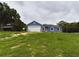 Charming one-story blue home with a two-car garage and stone accents at 1264 Buckeye Ne Rd, Winter Haven, FL 33881