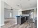 Spacious kitchen with an island and dark cabinets, open to the living area at 1264 Buckeye Ne Rd, Winter Haven, FL 33881