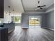 Open-concept living area with ceiling fan and sliding glass doors to patio at 1264 Buckeye Ne Rd, Winter Haven, FL 33881