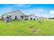Expansive back yard showing large manicured lawn, playground equipment, and partially covered patio space at 1274 Pintail Pl, Lakeland, FL 33813