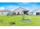 Large backyard featuring a play area, patio, and well-maintained lawn at 1274 Pintail Pl, Lakeland, FL 33813