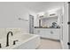 Bathroom with a soaking tub, double vanity, and modern fixtures at 1274 Pintail Pl, Lakeland, FL 33813