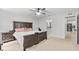 Comfortable bedroom with a wooden bed frame and access to an ensuite bathroom at 1274 Pintail Pl, Lakeland, FL 33813